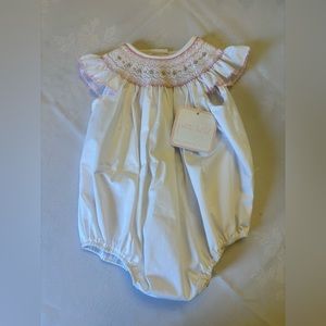 Baby Girls smocked bubble with rose detail.